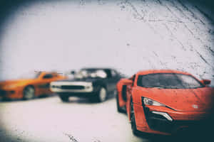 Trio Of Speed - Quick Cars In High Gear Wallpaper