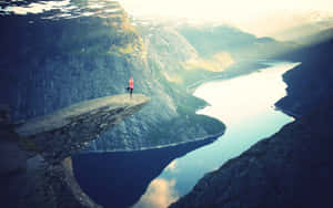 Trolltunga With Woman Doing Yoga Wallpaper