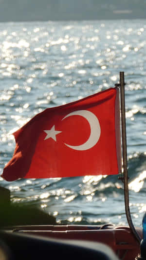 Turkish Flag Sunlit Water Backdrop Wallpaper