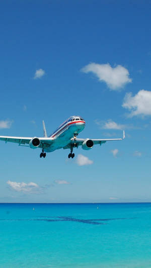 Turquoise Sea And Flying Airplane Iphone Wallpaper