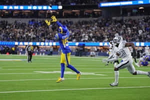 Tutu Atwell Catching Football During Game Wallpaper