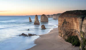 Twelve Apostles In Victoria Australia With Orange Horizon Wallpaper