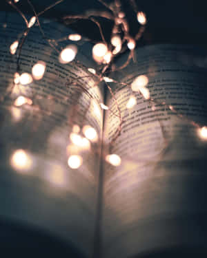 Twinkling Lights Over Open Book Wallpaper