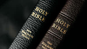 Two Bibles With The Word Holy On Them Wallpaper