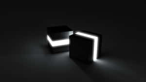 Two Black And White Cubes With A Light On Them Wallpaper