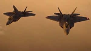 Two Fighter Jets Flying In The Sky Wallpaper