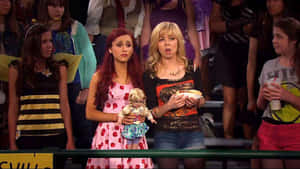 Two Girls In A Group Of Girls Holding A Doll Wallpaper