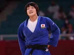 Two Martial Artists Showcasing Their Skills In Traditional Uniforms Wallpaper