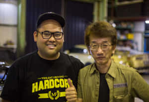 Two Men Garage Encounter Wallpaper