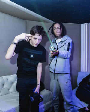 Two Men Posingwith Finger Gunsand Yo Yo Wallpaper