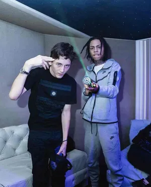 Two Men Posingwith Finger Gunsand Yo Yo Wallpaper