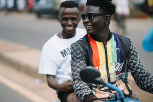 Two Men Riding Motorcycle In Sierra Leone Wallpaper