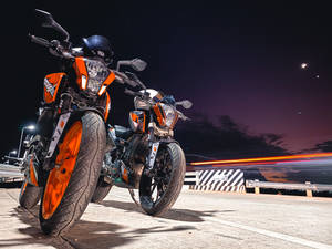 Two Parked Ktm Duke 200 At Night Wallpaper