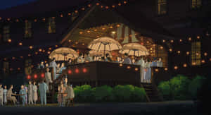 Two People Hold Each Other Tight In The Wind Wallpaper