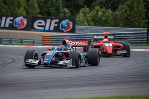 Two Racing Cars On A Track Wallpaper