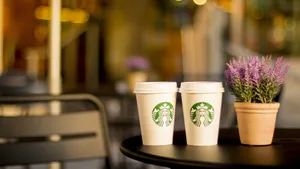 Two Starbucks Styro Cups On Table Wallpaper