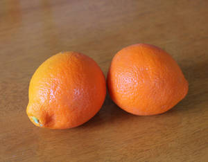 Two Tangelo Fruits On Wooden Table Wallpaper