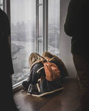 Two Teenage Student Girls Sitting Wallpaper