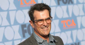 Ty Burrell Smiling During An Interview Wallpaper
