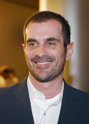 Ty Burrell Smiling In Black Suit Wallpaper