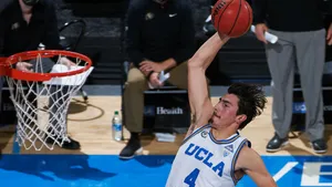 U C L A Basketball Player Dunking Wallpaper