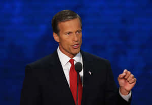 U.s. Senator John Thune In Formal Attire With A Dark Blue Background. Wallpaper