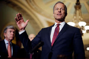 U.s Senator John Thune Raising His Hand Wallpaper