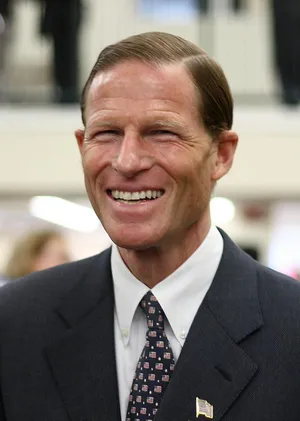 U.s. Senator Richard Blumenthal Speaking On Phone With A Smile Wallpaper