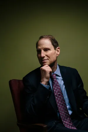 U.s Senator Ron Wyden Standing Against A Green Background Wallpaper