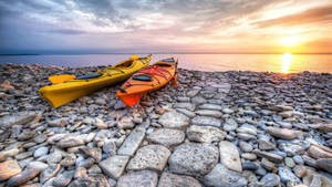 Ultra Hd Two Rowing Boats On Stone Beach Laptop Wallpaper