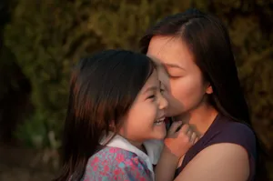 Unbreakable Bond: Mother And Daughter's Reciprocal Love Wallpaper