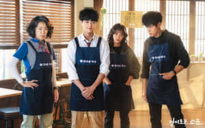 Uncanny Counter Cast Wearing Apron Wallpaper