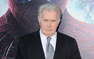 Uncle Ben Smiling Against A Rustic Backdrop Wallpaper