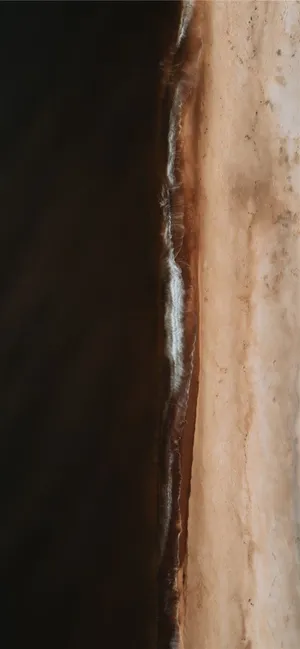 Uncover The Sophisticated Combination Of Black And Brown On The Stylish Dark Brown Iphone. Wallpaper