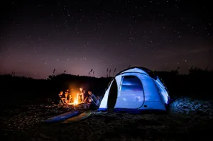 Unwinding By The Shore - A Serene Beach Camping Setup Wallpaper