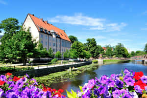 Uppsala River Viewwith Flowers Wallpaper