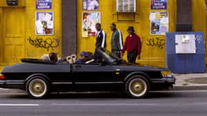 Urban Street Scene With Classic Car And People Wallpaper