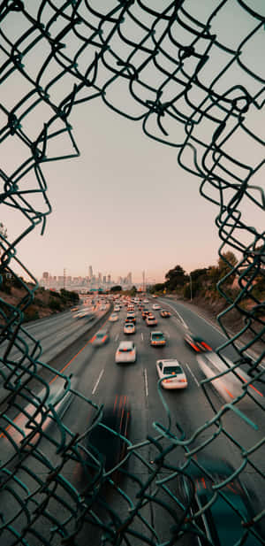 Urban Traffic Through Fence Wallpaper