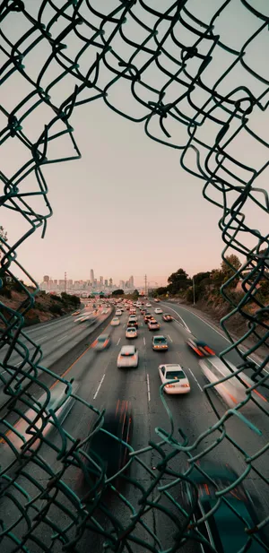 Urban Traffic Through Fence Wallpaper