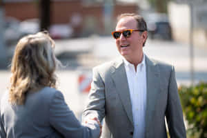 Us Representative Adam Schiff Engaged In A Friendly Handshake Wallpaper