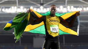 Usain Bolt Presenting The Jamaican Flag Wallpaper