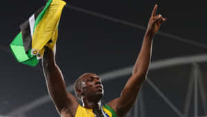 Usain Bolt Triumphantly Cheering With Jamaican Flag Wallpaper