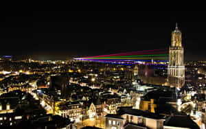 Utrecht Night Skylinewith Dom Towerand Laser Show Wallpaper