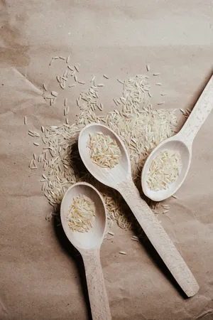 Variety Of Raw Rice On Three Spoons Wallpaper