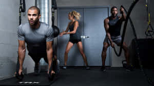 Various People Training At The Gym Wallpaper