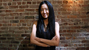 Vera Wang On Brick Wall Backdrop Wallpaper