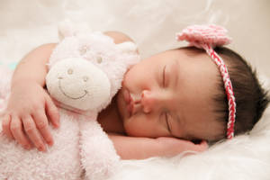 Very Cute Baby And Cow Toy Wallpaper