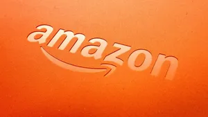Vibrant Amazon Uk Logo Against A Stunning Orange Backdrop Wallpaper