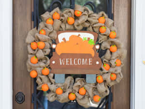 Vibrant And Colorful Fall Wreath Adorning A Rustic Door Wallpaper