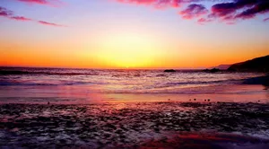 Vibrant And Colorful Sunset By The Beach Wallpaper